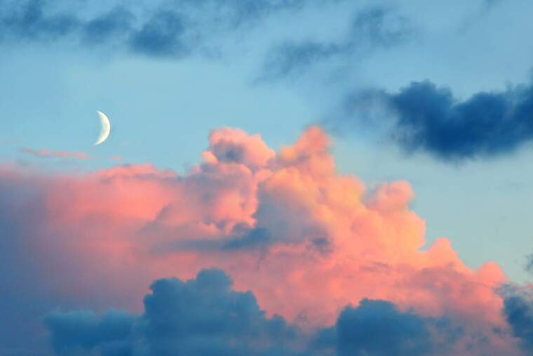 Blue sky with the moon and pink clouds