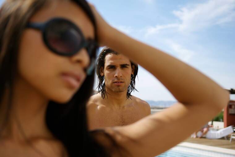 Man staring a ta woman with at the beach