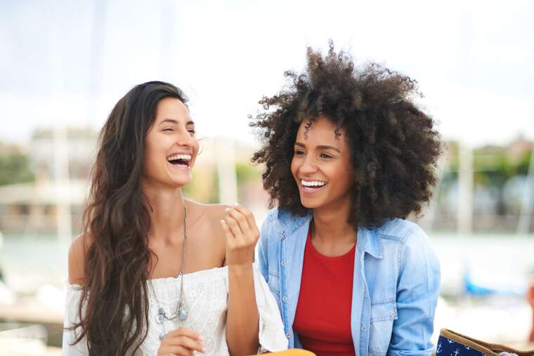 Two girls laughing together