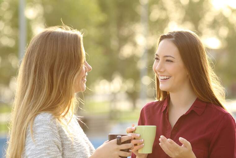 Two women talking with coffee