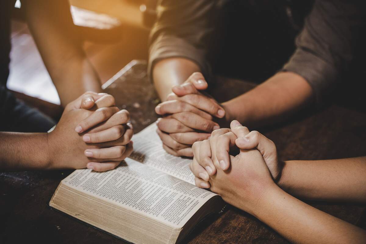 Group of people praying together