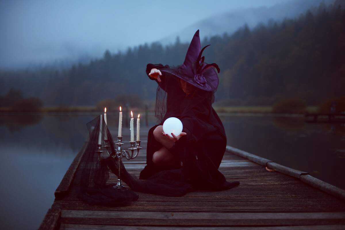 Witch near a lake witch candles