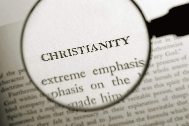 A magnifying glass and a book about Christianity