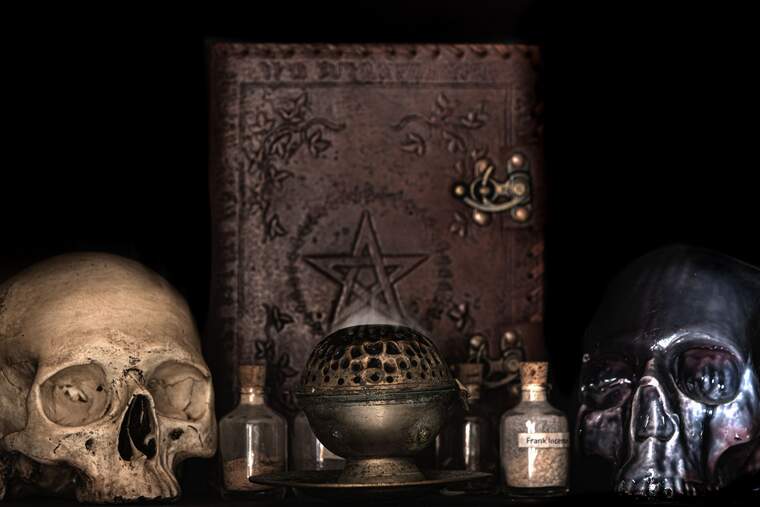 Skulls and a book of Black Magic