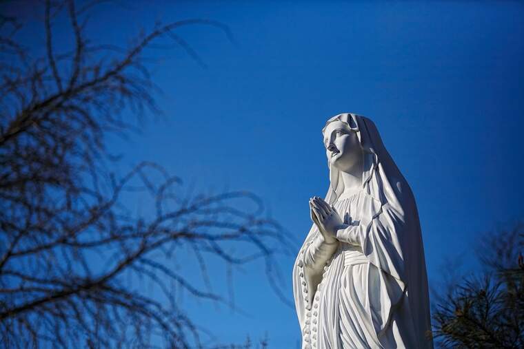 Statue of Virgin Mary with a blue sky