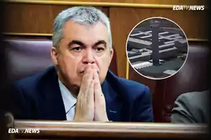 Hombre de cabello canoso con expresión seria y manos juntas frente a su rostro sentado en un banco de madera con una imagen circular de una prisión en la esquina superior derecha y el texto EDATV.NEWS en la imagen